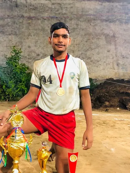 A proud player with his medals and trophies after securing first position.
