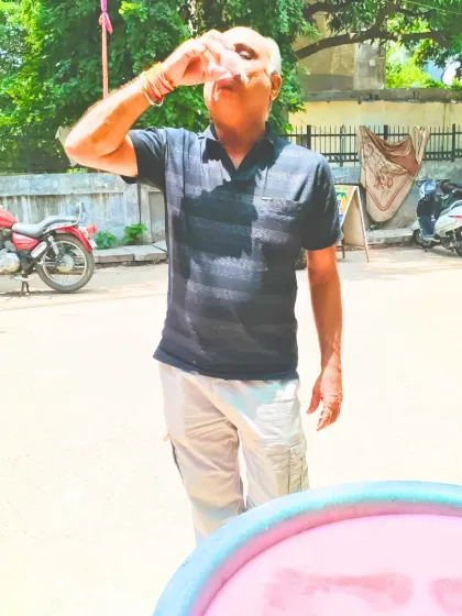 An elderly man enjoys a refreshing glass of Chabeel. It's a simple pleasure, offered with love, that provides much-needed relief from the summer heat.
