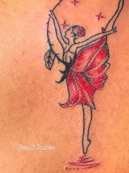 A beautiful fine-line tattoo of a ballerina whose dress is a red flower. A creative and graceful design.