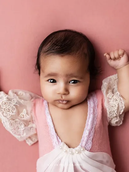 This little cupcake is wide awake. I love capturing their direct gaze. The delicate lace and pearl details on her pink outfit are just beautiful.