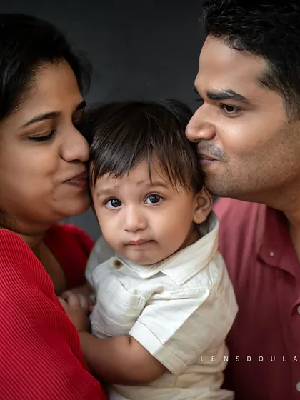 Sometimes the most powerful portraits are the simplest. This close-up captures the pure, overwhelming love of new parents, a quiet moment of family bliss that tells a whole story.