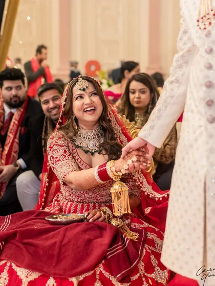 Pure joy captured in a single frame. The bride's laughter is infectious, and her makeup looks stunning even in this candid, happy moment.