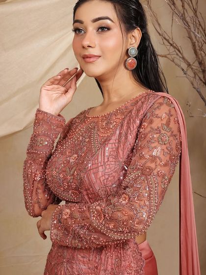 A closer look at the exquisite hand-embroidery on our rose-dust lehenga-saree. The sheer sleeves and intricate sequin work add a layer of sophistication and artistry.