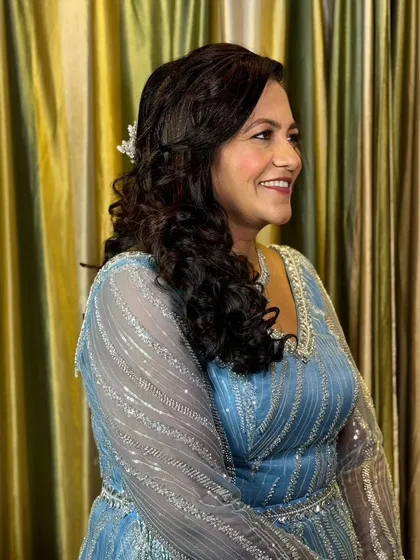 A beautiful party look for this guest in a sparkling blue gown. The makeup is glamorous yet refined, and the soft curls add a touch of romance.