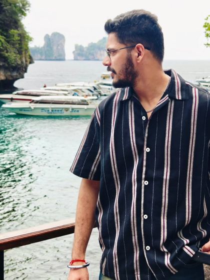 A candid shot of me looking out over the stunning Phi Phi Islands in Thailand. This is the kind of moment I live for, blending travel with a sense of personal style.