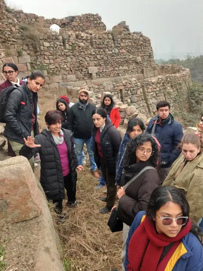 Explaining the architectural details of the Tughlaq-era stonework. Even in decay, the craftsmanship and sheer scale of the construction are awe-inspiring.
