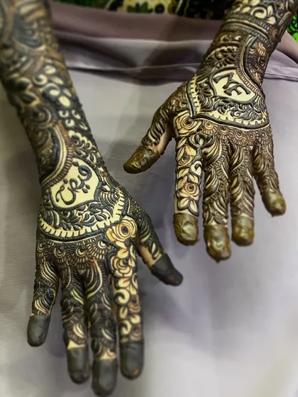 Learn to personalize bridal henna by elegantly weaving the groom's name into the design, as shown here.