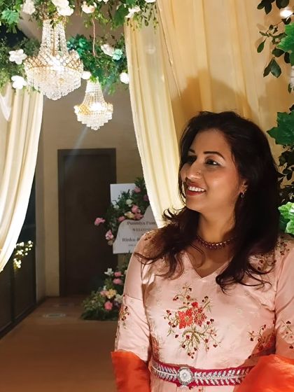 A candid shot, smiling as I look at the beautiful event setup. The grand chandeliers and drapes created a magical atmosphere.