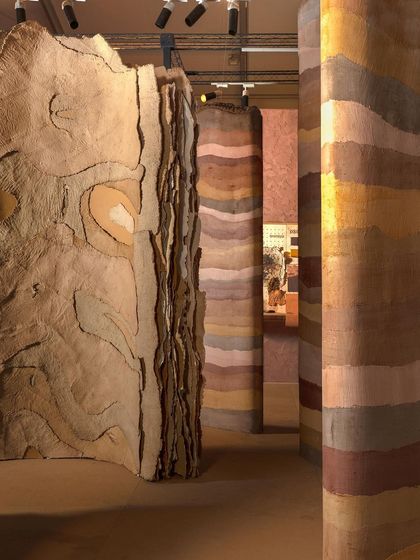 The 'Soil' installation features towering panels with layered, geological textures. This view shows the scale and complexity of the surfaces we created to represent the historical and raw essence of the theme.