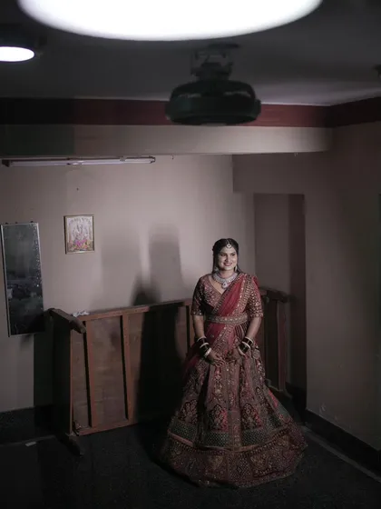 A simple yet elegant portrait of the bride at her reception. The dramatic top-down lighting creates a unique and striking effect.