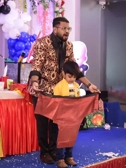 The look of surprise says it all. This young volunteer is having a blast with a comedy magic prop during a fun-filled birthday party performance.