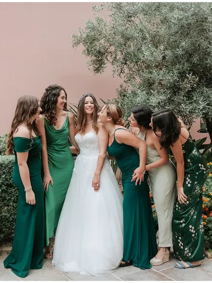 It's all about the girl tribe! A bride and her bridesmaids sharing a laugh, creating beautiful memories together.