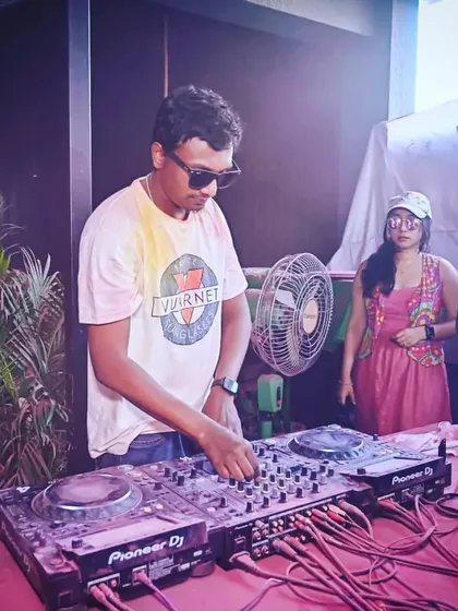 At the DJ console during a sun-drenched Holi party. I'm focused on mixing the perfect set of Bollywood and commercial hits for the occasion.