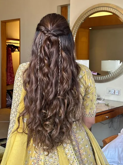 A closer view of the half-up twist with hair chains, showing the detail of the simple braid and the sparkle of the accessories.