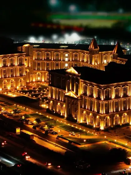 An iconic nighttime aerial shot of the beautifully illuminated Dayananda Sagar University. This image captures the grandeur and scale of the campus, resembling a European palace in the heart of Bangalore.