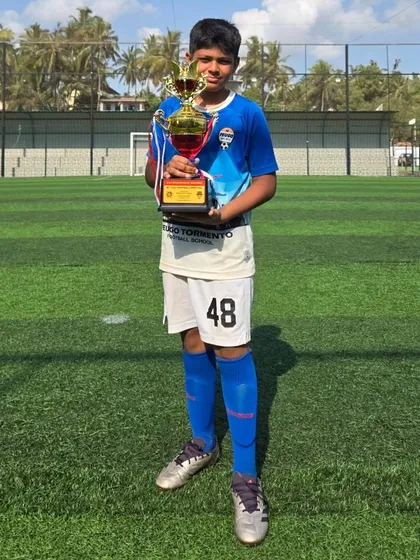 This U14 player holds his team's trophy after a great tournament.