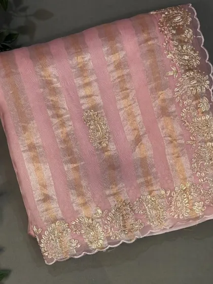 A full view of the pastel pink tissue stripes organza saree, showing its beautiful drape and craftsmanship.