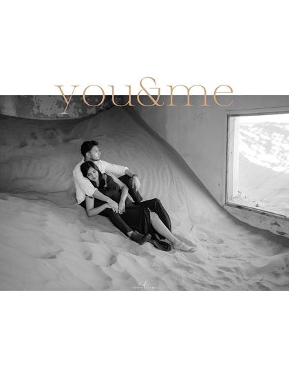"You & Me," a timeless black and white portrait from a unique pre-wedding shoot in Dubai's "ghost village," where sand fills the buildings.