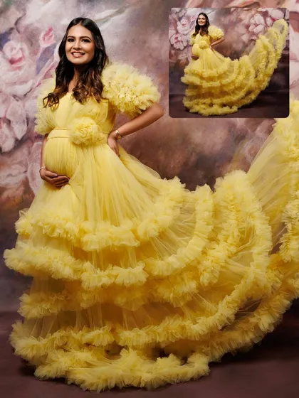 Making every mom-to-be feel like a queen is my mission. This dramatic, multi-layered yellow tulle gown with its magnificent train does just that. It’s one of the statement pieces from my studio wardrobe, perfect for creating breathtaking, high-fashion maternity portraits.
