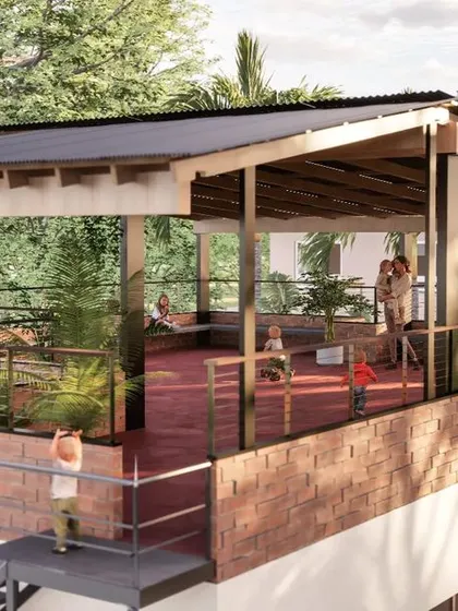 A render showing the rooftop terrace designed for community activities. The space features a cool red oxide floor, a protective roof for shade, and built-in seating along the edges. This addition significantly increased the usable area of the school without a large expense.