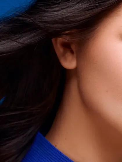 An artistic crop focusing on the side of the face and the texture of the hair. This type of shot adds a creative flair to a beauty or hair campaign series.
