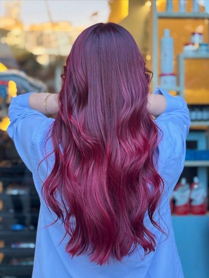 Shades that speak louder than words. This magenta-red look is vibrant and playful, perfect for anyone looking to express their personality through their hair.