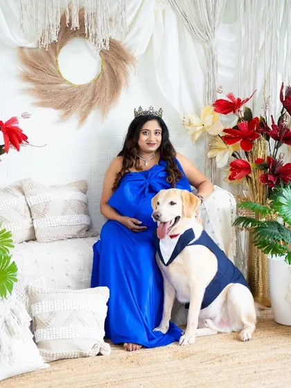 A beautiful family portrait with a very well-behaved dog. This image perfectly captures the love and excitement of the entire family, paws and all.