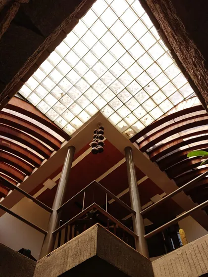 Let there be light. A view looking directly up into a glass-block skylight, which diffuses sunlight and casts a gentle glow over the space below. The geometric grid of the skylight contrasts with the curved architectural elements.