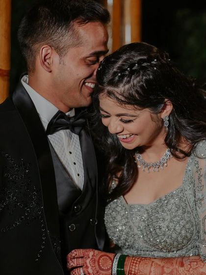 A sweet, intimate moment between the couple. The bride's makeup looks flawless even in this close-up, candid shot.