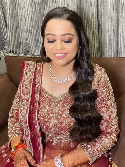A close-up of the bride's soft and glamorous makeup. The look is designed to enhance her features and give her a radiant glow.