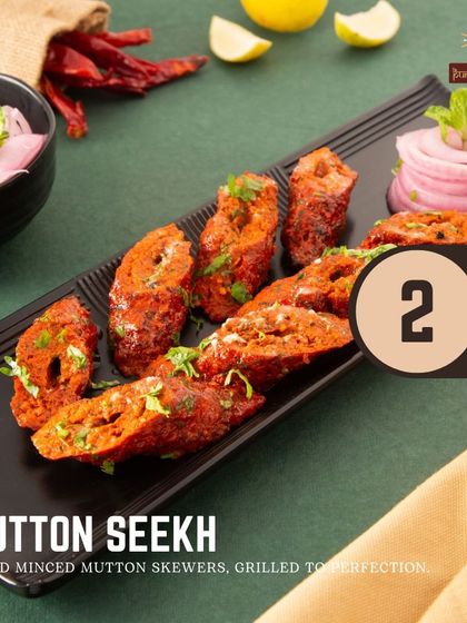 The Mutton Seekh Kebab is a timeless classic. We use spiced minced mutton, skewer it, and grill it to perfection for a tender and flavorful bite every time.