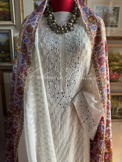 A straight-on mannequin shot of the suit with the colorful dupatta.