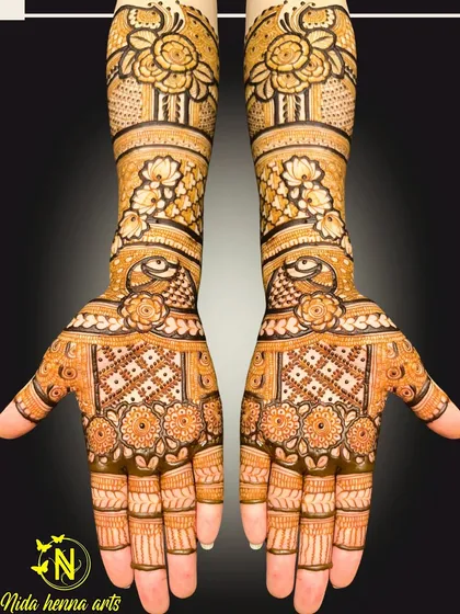 A classic Indian bridal design with full coverage. The pattern is symmetrical on both hands and features traditional elements like the evil eye motif and floral jaal work.
