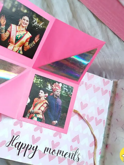 An interactive pop-up card inside a wedding-themed scrapbook, adding a fun surprise.