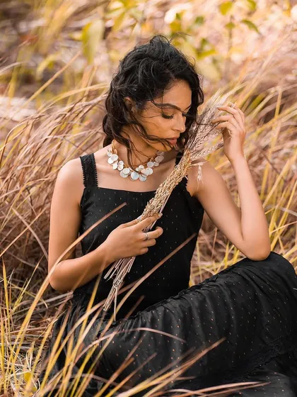 A messy, textured updo for an outdoor shoot. This hairstyle is romantic and effortless, ideal for a windswept, natural setting.