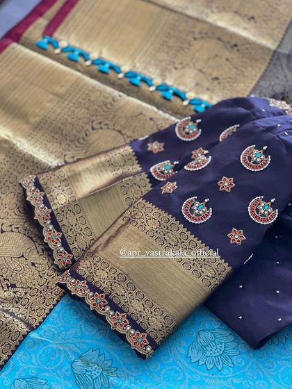 A full view of the navy blue blouse sleeves, showing the rich combination of brocade and embroidery.