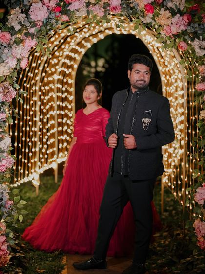 The floral and light archway provides a stunning entrance for this couple's grand and stylish portrait.