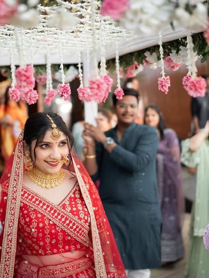 The bride's grand entrance under a 'phoolon ki chadar' for her 'first look'. A beautiful and traditional moment.