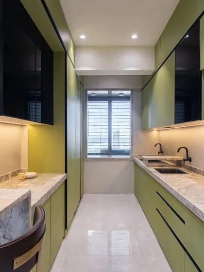 This perspective highlights the galley layout of the kitchen, designed for an efficient workflow. The dual sinks and ample counter space on both sides make meal prep and cleanup a breeze.