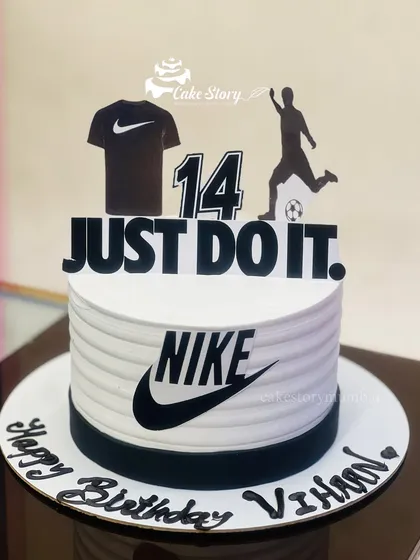 A 'Just Do It' cake for a Nike and football fan's 14th birthday. The clean, black and white design features the iconic Nike swoosh and logo.