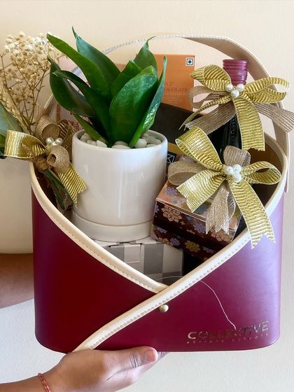 Holding up one of our unique corporate hampers. The modern, envelope-style container is easy to carry and makes a strong visual statement, perfect for impressing clients and partners.