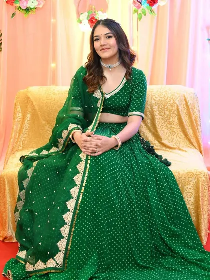 Dhruvi seated and looking serene during her Kankotri function. The soft makeup ensures she looks comfortable and beautiful throughout the ceremonies.