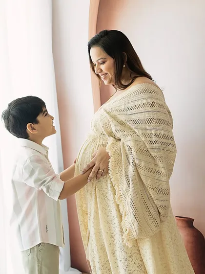 The look of love between a mother and her firstborn as they anticipate the new baby. The soft, natural light adds to the warmth of the scene.