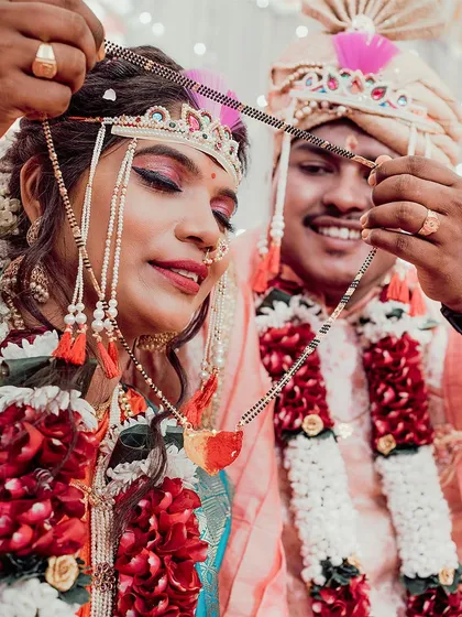 The sacred Mangalsutra moment. We focus on this pivotal ritual of a Maharashtrian wedding, capturing the groom tying the sacred necklace, symbolizing their union.