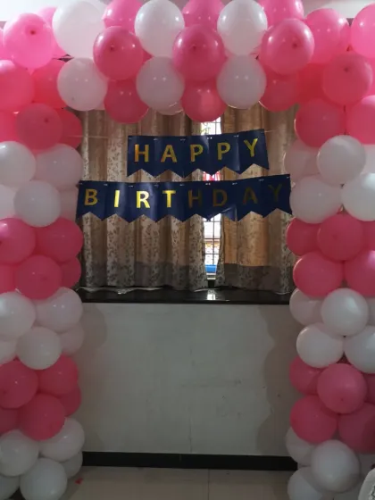 The completed pink and white balloon arch, a beautiful entrance for any birthday party.