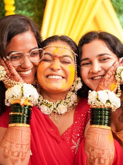 A beautiful moment of joy as the bride is surrounded by her friends and family during the Haldi ceremony.