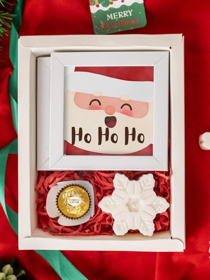 A simple and sweet Christmas gift, this box includes a Santa frame, a Ferrero Rocher chocolate, and a snowflake-shaped candle. It's an adorable and budget-friendly option.