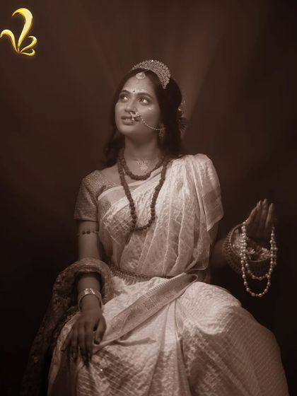 This sepia-toned image is from our Brahmacharini concept, representing discipline and learning. The simple white saree and rudraksha beads were chosen to convey a sense of focus and self-discovery, showing how styling can tell a story of personal growth.