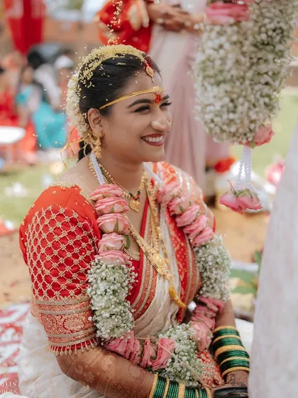The happy smile of a bride during her wedding rituals. The makeup is sweat-proof and long-lasting, keeping her looking perfect throughout the day.