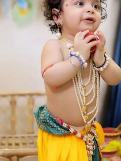 A close-up shot capturing the delightful details of a baby Krishna, from the pearl necklaces to the playful expression.